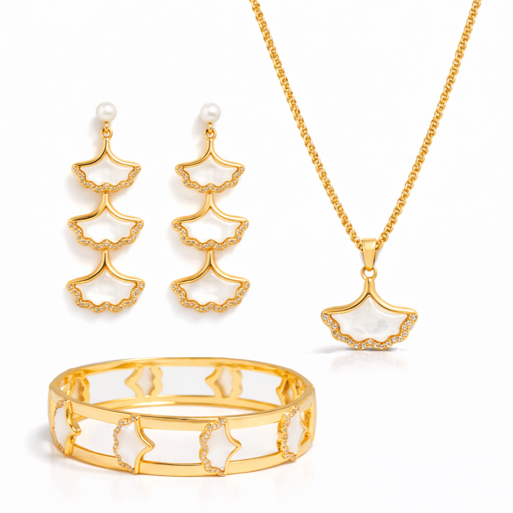Gold jewelry set with earrings, necklace, and bracelet on a white background