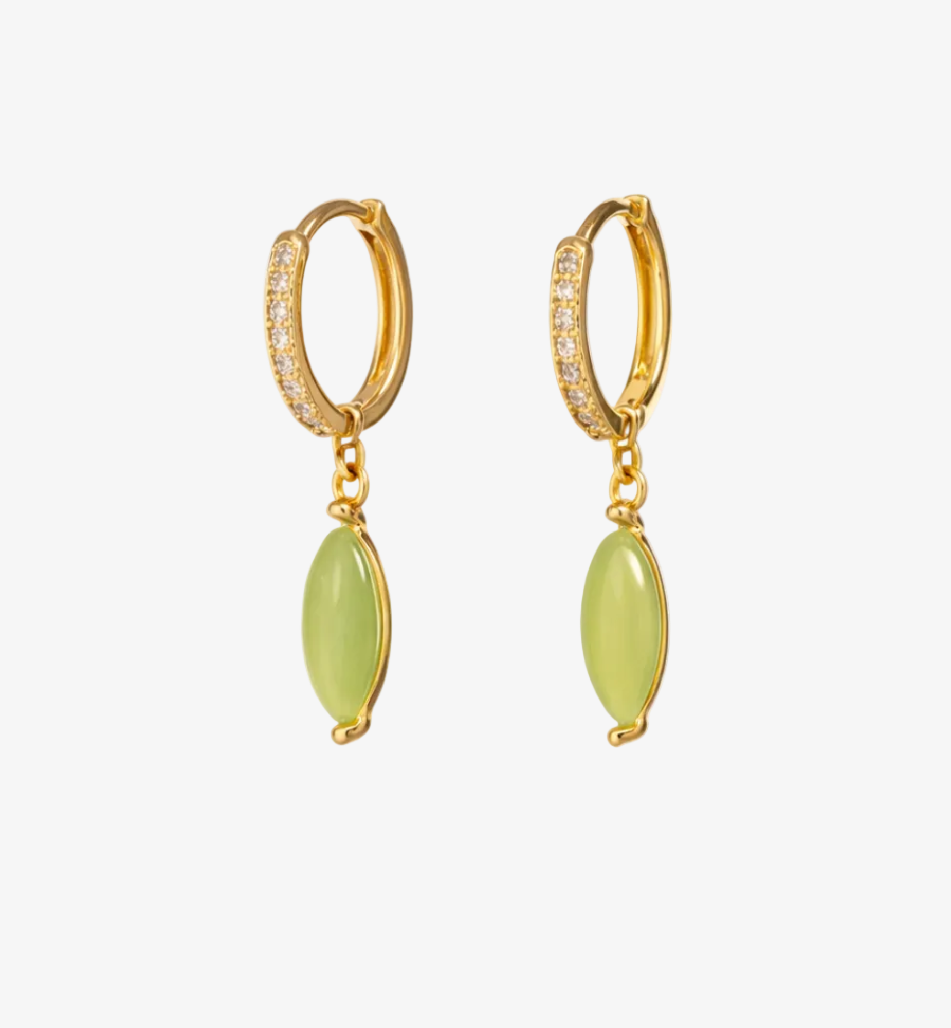 Gold hoop earrings with green gemstones on a white background