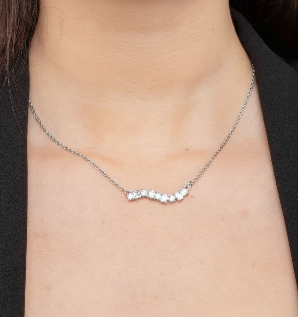 Silver necklace with small diamonds on a person's neck