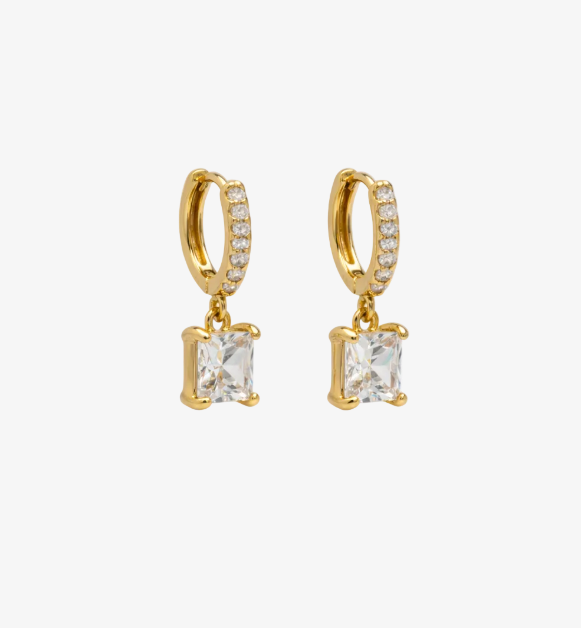 Gold hoop earrings with square gemstones on a white background