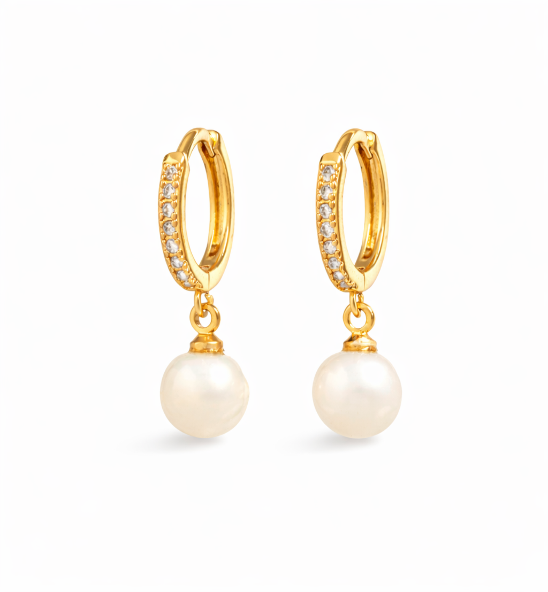 Gold hoop earrings with pearl drops on a white background