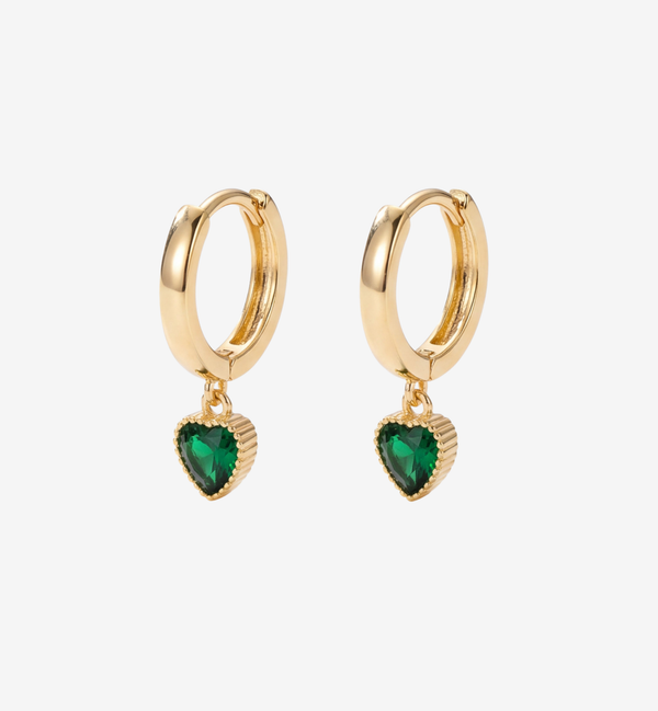 Gold hoop earrings with heart-shaped green gemstones on a white background