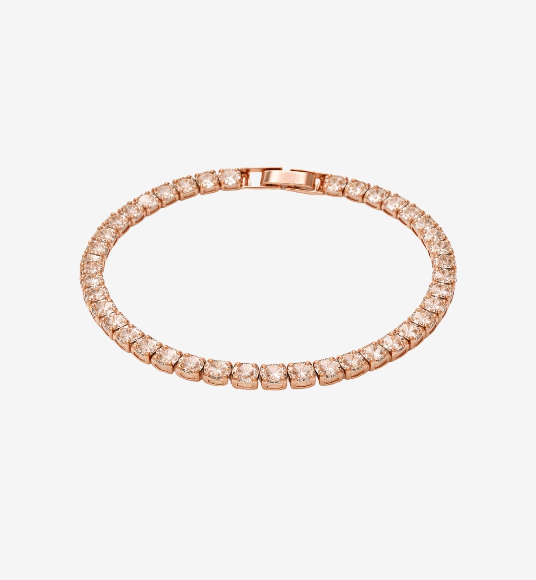 Rose gold bracelet with diamonds on a light gray background