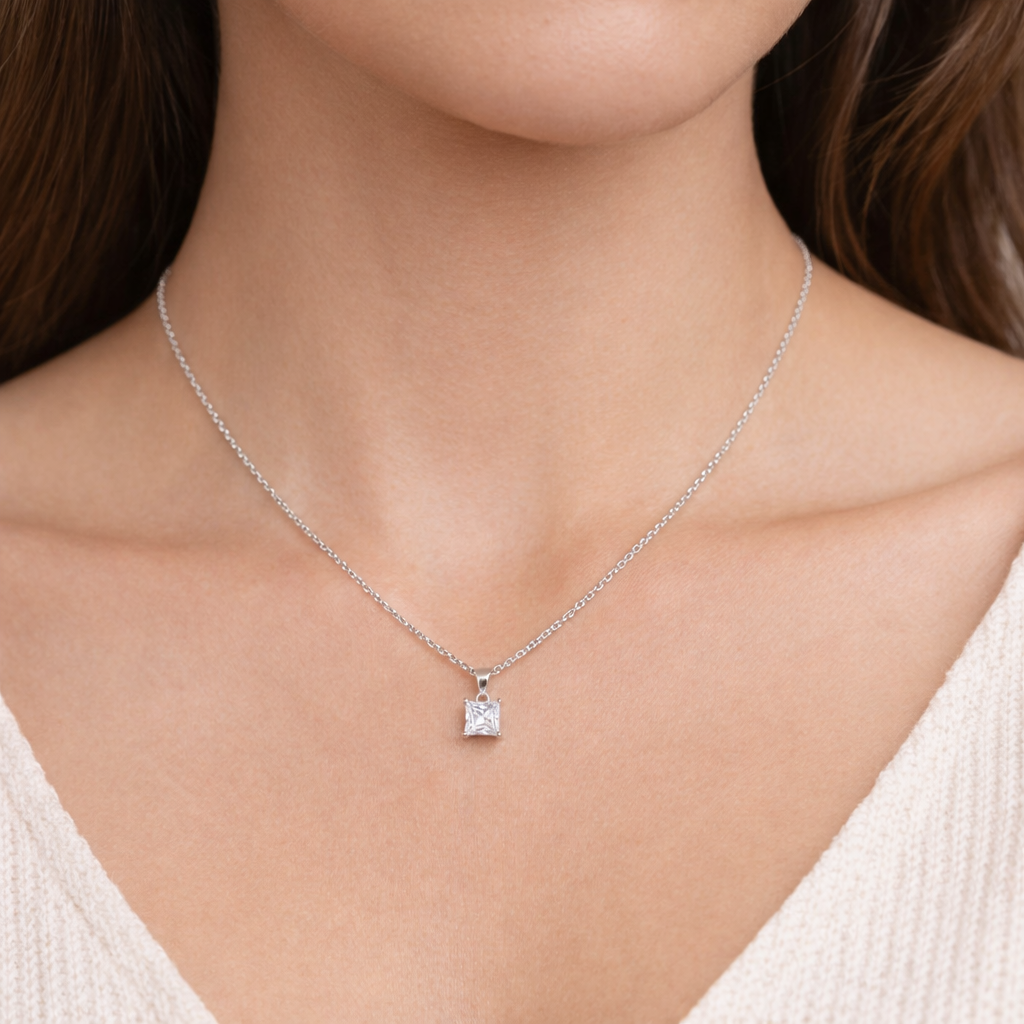 Necklace with a square pendant worn by a person