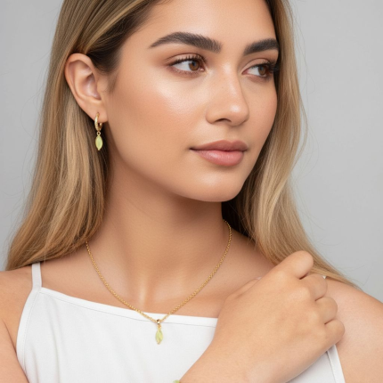 Woman wearing gold jewelry against a neutral background