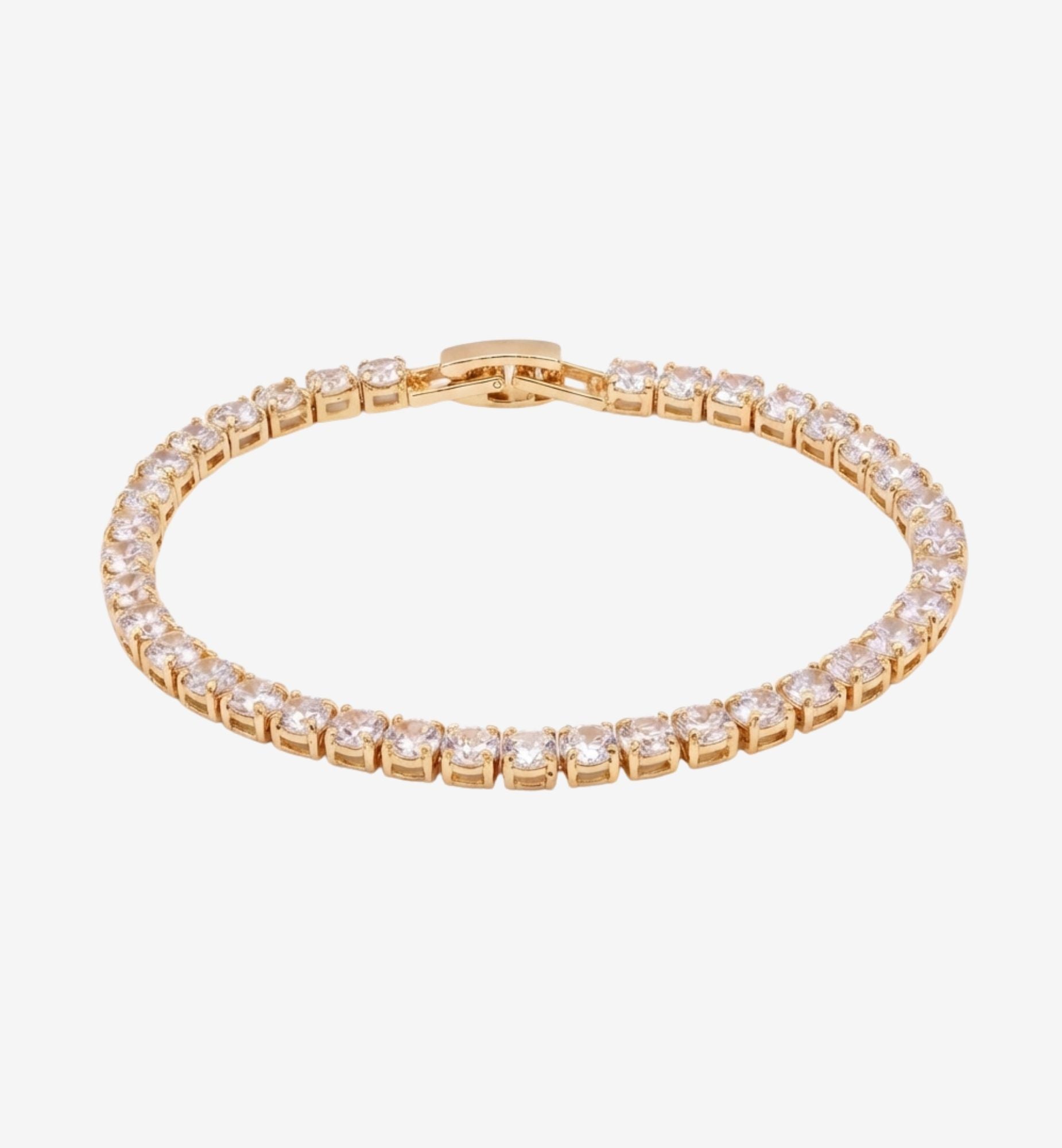Gold bracelet with clear stones on a white background