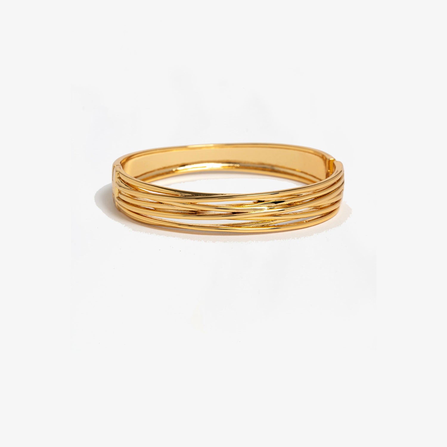 Gold bangle on a white background